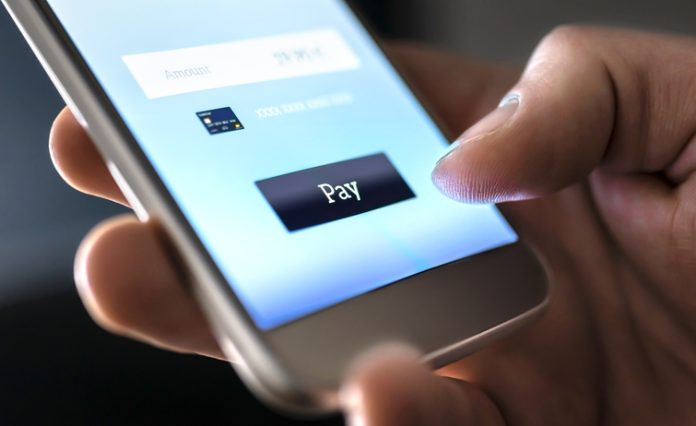 Mobile payment with wallet app and wireless nfc technology. Man paying and shopping with smartphone application and credit card information. Transaction services