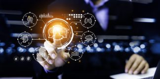 Businessman hand holding AI icon