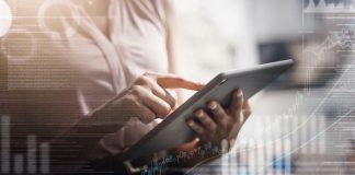 woman holding a tablet with graphs