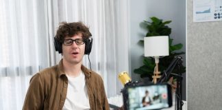 man recording himself while singing