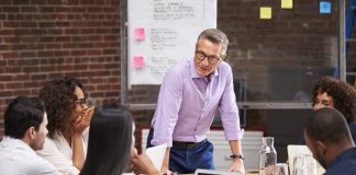 Businessman standing and leading the meeting