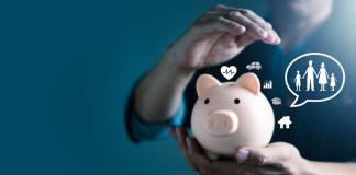 Man hand on piggy bank for life insurance