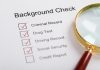 Background check with magnifying glass