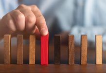 Understanding Types of Business Risks and Strategies for Effective Management business man try choose red wood block on wooden table and dark background business organization startup concept