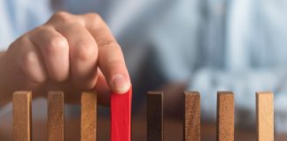 business man try choose red wood block on wooden table and dark background business organization startup concept