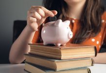 woman puts coins in the piggy bank for eduqation
