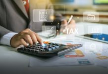 businessman using calculator for tax planning
