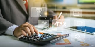 businessman using calculator for tax planning