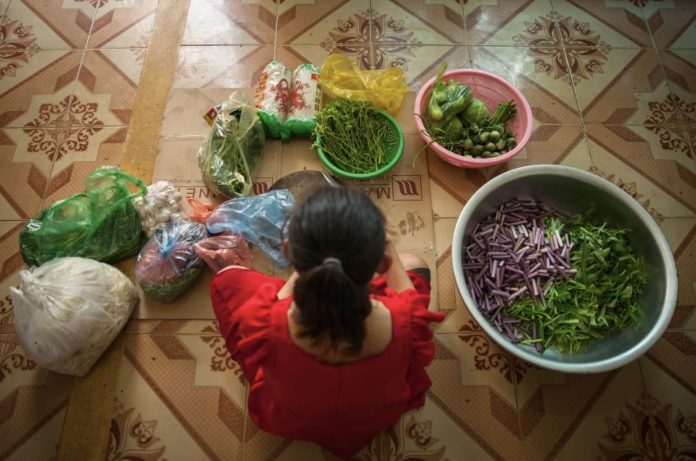 Woman-surrounded-with-vegetables