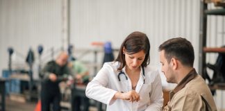 Female doctor examining factory worker