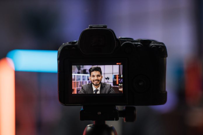 Headshot of a businessman from camera screen