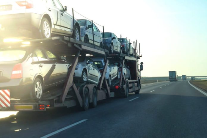 Cars being transported on a long vehicle car carrier