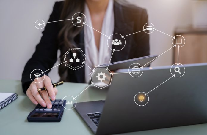 Female accountant holding a pen and using calculator