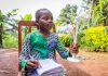 African child holding wind turbine