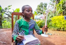 African child holding wind turbine