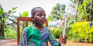 African child holding wind turbine