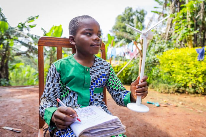 African child holding wind turbine