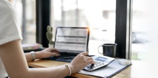 Accountant working Financial investment on calculator