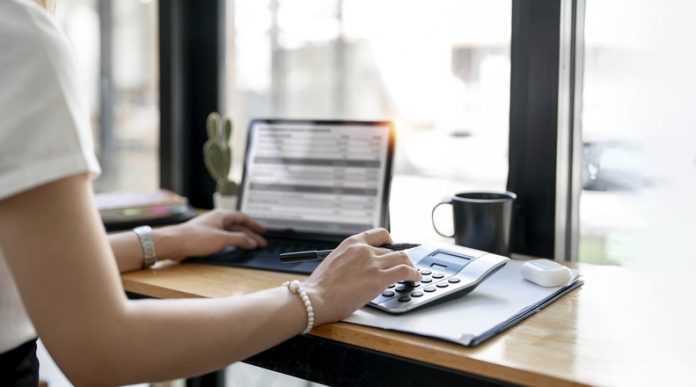 Accountant working Financial investment on calculator