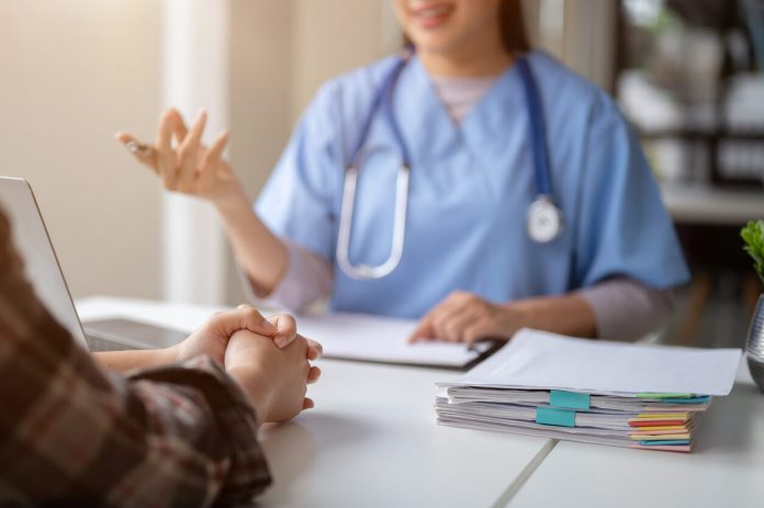 Close-up hand image of a serious patient having a medical consultation with a professional doctor at a hospital