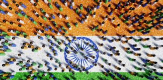 Peg humans standing on a national flag of India. Illustration of the concept of Indian population