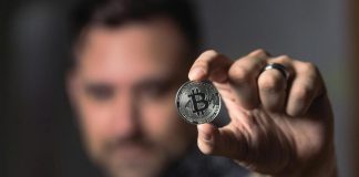 Person Holding Silver Bitcoin Coin