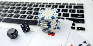 Business online poker games with laptop two black dice playing card and casino chips.