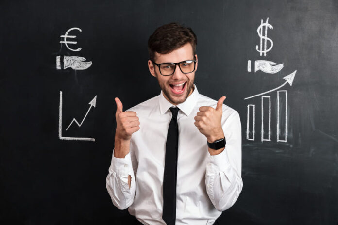 Happy businessman in white shirt showing thumb up gesture with two hands