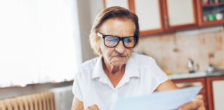 Senior woman at home checking her finances and investments