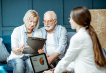 Senior couple with consultant at the office