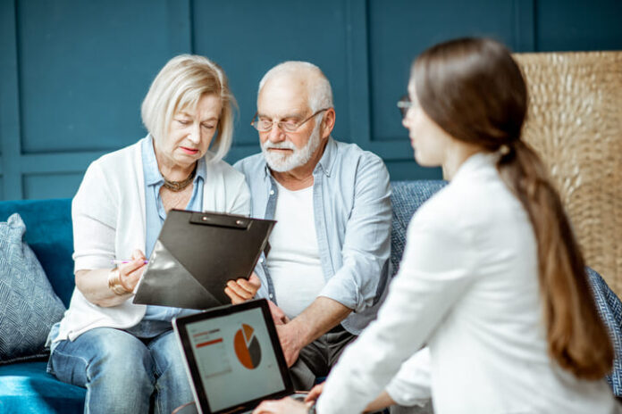 Senior couple with consultant at the office