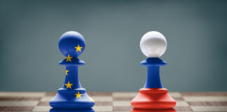 European Union and Russia conflict. Flags on chess pawns on a chess board.