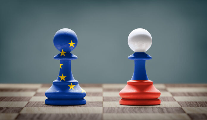 European Union and Russia conflict. Flags on chess pawns on a chess board.