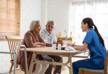 Asian caregiver nurse examine senior couple patient at home together