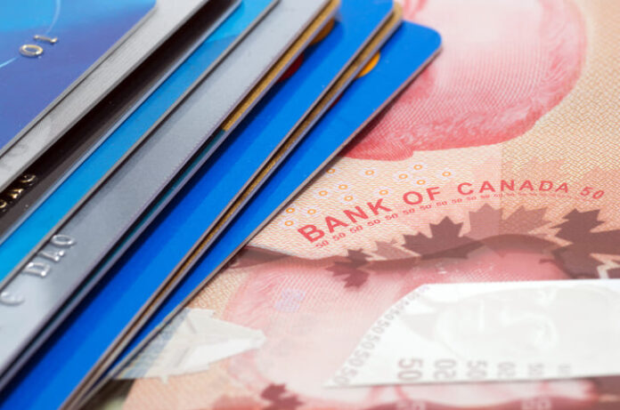 Stack of credit cards on a bank note of canada