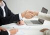 HR handshaking successful candidate getting hired at new job, closeup