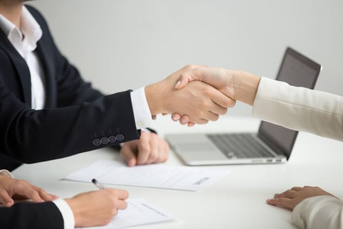 HR handshaking successful candidate getting hired at new job, closeup