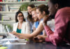 Cheerful coworkers in office during meeting