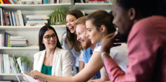 Cheerful coworkers in office during meeting