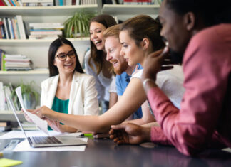 Cheerful coworkers in office during meeting