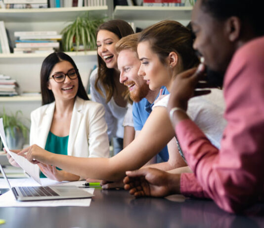 Cheerful coworkers in office during meeting