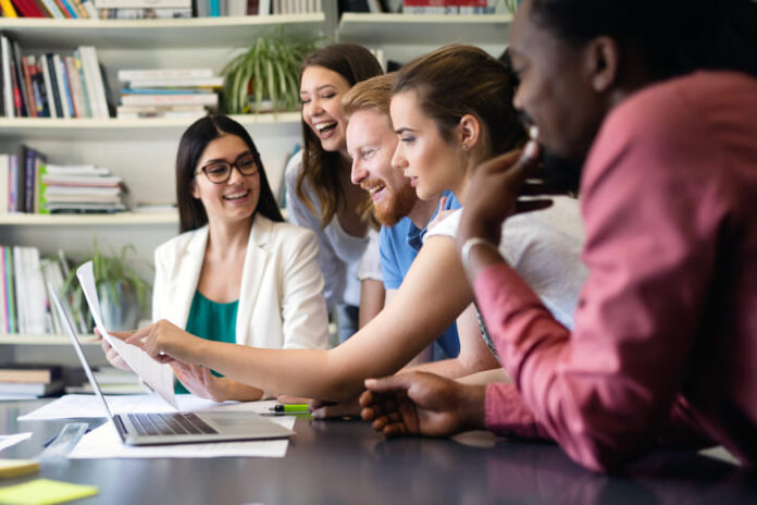 Cheerful coworkers in office during meeting