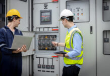 Electrical engineer man checking Power Distribution Cabinet in the control room