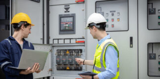 Electrical engineer man checking Power Distribution Cabinet in the control room