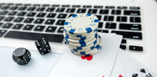 Business online poker games with laptop two black dice playing card and casino chips.