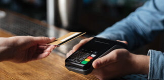 Client hand holds credit card