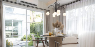 Plate setting on round table in modern style dining room interior of modern home