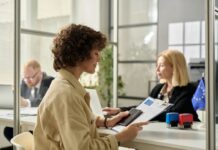 Smiling young woman holding approved visa