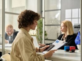 Why Investors are All About that VIP Life with the Immigrant Investor Program Smiling young woman holding approved visa