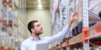 Businessman with tablet pc at warehouse